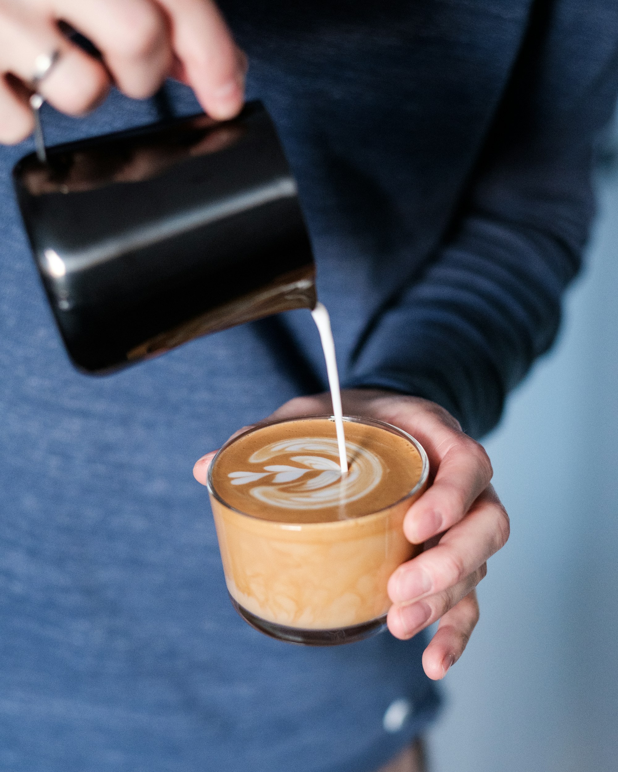 Pouring a flat white with our house beans